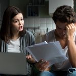 Angry wife scolding blaming upset husband of unpaid bills