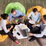 People Discussing Ideas and Sitting at Cafe Table