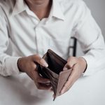 businessman saving money,Man carrying a wallet in hand, the doll