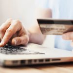 Man is shopping online with laptop