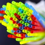 colored plastic cocktail tubes standing in a glass