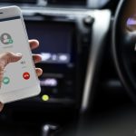 Woman using the mobile while in the car