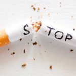 broken cigarette with the word stop. stop smoking concept closeup