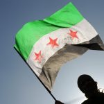 Syrian refugees wave the Free Syrian fla